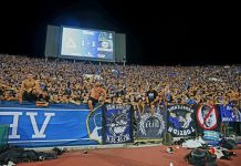 Левски намалява билетите за Лига Европа Full stadium crowd in blue, fans leaning over the barrier with banners during a night football match when the scoreboard shows 1-1.