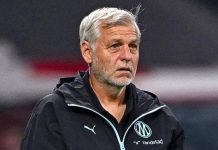 Напрежение в Марсилия: бъдещето на Женесио вече е под въпрос Football coach with gray hair in a black jacket, standing on the sidelines during a match with team logos visible on his chest.
