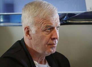Сираков: Вярвам, че до три години Левски ще има нов дом Close-up of a senior man with short white hair and a black blazer, looking to the right in an indoor setting.