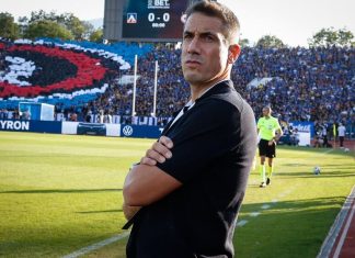 Веласкес пое вината след загубата от ЦСКА: Второто полувреме беше ужасно A soccer coach stands with arms crossed on the sideline as a packed stadium watches a match, the scoreboard showing 0-0 in the background.
