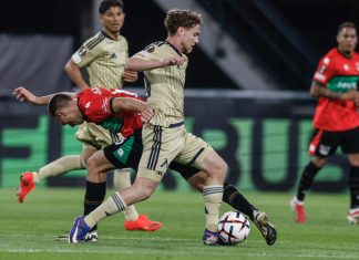 Букмейкърите дават сериозно предимство на Виктория Пилзен срещу Левски Soccer players in beige and red-green kits compete for the ball; the beige player dribbles forward as a red-green defender approaches from the left.