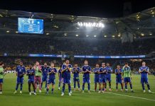Чуждестранни клубове следят две от скъпите попълнения на Левски Soccer team in blue uniforms standing in a line on a green field as fans watch from the stands at night.