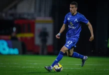 Добри новини за Левски: Акрам Бурас се завърна към тренировките Soccer player in blue uniform dribbling a yellow-and-purple ball on a green pitch at night, number 47 visible on shorts.