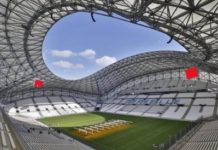 Фенове на Левски щурмуват Марсилия за мача от Лига Европа Interior of a modern domed stadium with a large circular skylight, green field, and white seating surrounding it