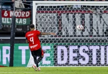 Голмайсторът за НЕК: Вратарят на Левски ми даде добро подаване Soccer player in a red jersey number 9 takes a shot toward the goal as the ball is in the air near the net.