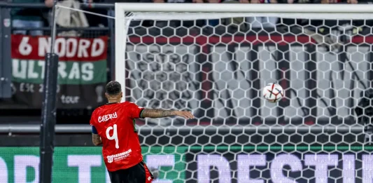 Голмайсторът за НЕК: Вратарят на Левски ми даде добро подаване Soccer player in a red jersey number 9 takes a shot toward the goal as the ball is in the air near the net.