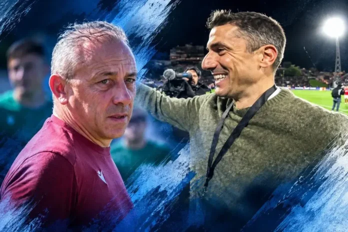 Two men on a football field share a moment, one in maroon shirt looking serious while the other smiles with a medal on a lanyard beside him, under stadium lights.