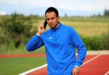 Кирил Лулев за Левски, битката за титлата и новите треньори на ЦСКА и Лудогорец Man in a blue athletic jacket on a running track, talking on a smartphone.