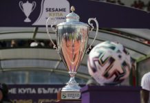 Левски и ЦСКА излизат в един и същи ден за SESAME Купа на България Shiny silver trophy with ornate handles on a wooden base, in a stadium setting, with a colorful soccer ball nearby and 'Sesame Cup' visible on the base.
