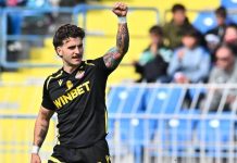 Левски набеляза две звезди на Ботев Пловдив Soccer player in a black kit with WINBET raises his right fist on the pitch, crowd in the stands behind.