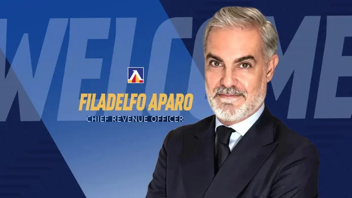 Headshot of Filadelfo Aparo, Chief Revenue Officer, in a dark suit against a blue branding background.