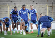 Левски обяви програмата си преди гостуването на НЕК в Лига Европа Soccer players in blue training kits sprinting from a starting line on a green field during practice.