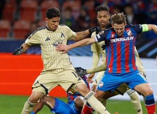 Левски си осигури сериозно предимство за следващия сезон Soccer players in beige and blue-red kits clash for the ball on the field during a match.