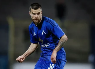 Левски остава без Радослав Кирилов до края на годината! Националът претърпя втора операция Soccer player in a blue kit sprinting on a dim field, LMS BET sponsor logo visible.
