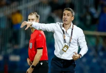 Левски се превърна в най-силния период в кариерата на Хулио Веласкес Soccer coach in a white shirt on the sideline, gesturing with his arm while a referee in red stands nearby during a match.