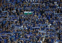 Левски с важна информация за феновете си за мача с Арда Crowd of blue-clad soccer fans in a stadium, many holding striped scarves overhead.