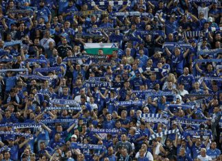 Левски с важна информация за феновете си за мача с Арда Crowd of blue-clad soccer fans in a stadium, many holding striped scarves overhead.