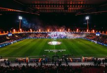 Левски с важни указания към феновете преди мача с Виктория Пилзен Nighttime UEFA Europa League stadium celebration: circular center-circle display with players around the emblem, flames and smoke in stands, full stands.