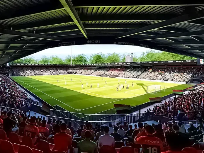 Soccer match in a sunlit stadium viewed from under a shaded stands roof with cheering crowd and green pitch.