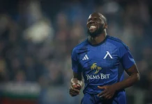 Мустафа Сангаре: кариера и представяне на футболиста Male footballer in a blue kit celebrating with eyes closed and teeth visible on the field