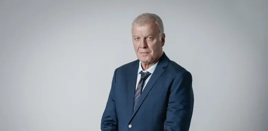 Наско Сираков е наказвал Спартак Плевен във финал Older man in a navy suit and striped tie posing against a light gray studio backdrop, hands clasped in front.