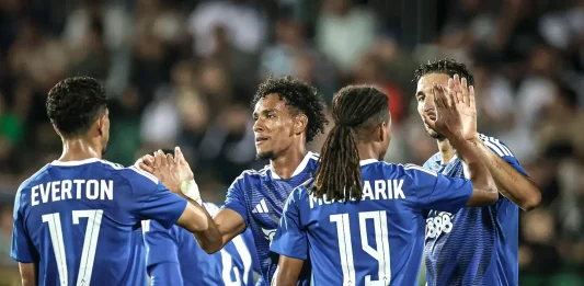 Нидерландските медии впечатлени от Левски преди сблъсъка с НЕК Soccer players in blue jerseys celebrate with high-fives on the field, crowd in the stands behind them.