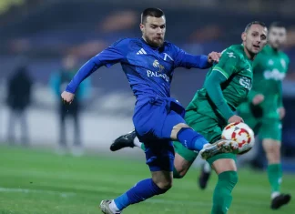 Обнадеждаващи новини за Радослав Кирилов Soccer player in a blue kit kicking a ball during a match, with a green-clad opponent nearby on the field.