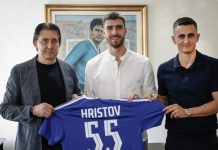 Петко Христов още чака своя шанс в Левски Three men stand indoors, presenting a blue sports jersey labeled Hristov 55.