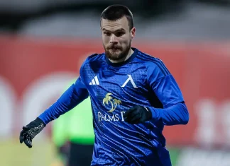 Радослав Кирилов – профил и кариера на футболиста Male soccer goalkeeper in a blue kit and gloves, sprinting on the field during practice or a match.