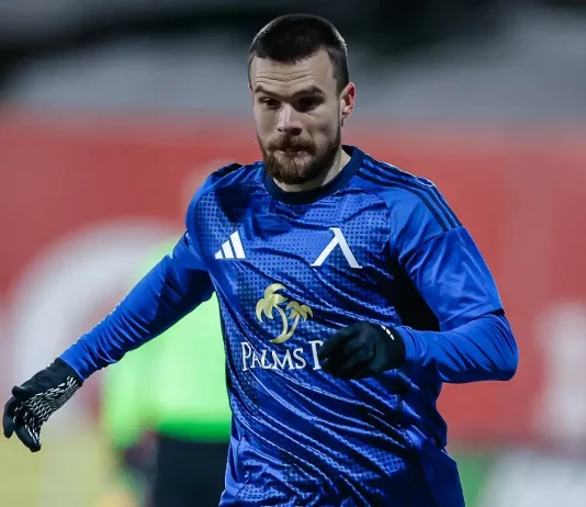 Радослав Кирилов – профил и кариера на футболиста Male soccer goalkeeper in a blue kit and gloves, sprinting on the field during practice or a match.