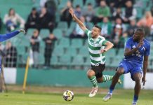 Стадион „Тича“ вече не плаши Левски Soccer match in progress: a player in a green-and-white striped jersey drives the ball as blue-team players defender advance nearby.