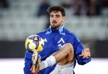 Стипе Вуликич: профил, отбори и резултати Soccer player in a blue training jacket traps a yellow-purple ball with his foot mid-action on the field.