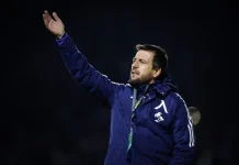 Тасевски: Левски върви към нивото на АЕК, но е нужно време Coach in a blue jacket waving his right hand at a night sports event