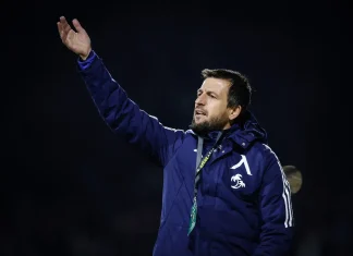 Тасевски: Левски върви към нивото на АЕК, но е нужно време Coach in a blue jacket waving his right hand at a night sports event