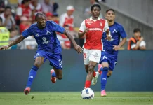 Турски клубове следят звезда на Левски Soccer player in blue kit lunges toward the ball as other players in blue and red kits chase behind on a grassy field.