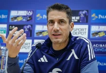 Веласкес готви промени в Левски, но няма да пипа най-силното си оръжие Man in a blue athletic jacket speaks at a press conference with a microphone in front; sponsor boards are blurred in the background.