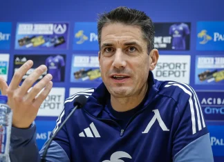 Веласкес готви промени в Левски, но няма да пипа най-силното си оръжие Man in a blue athletic jacket speaks at a press conference with a microphone in front; sponsor boards are blurred in the background.